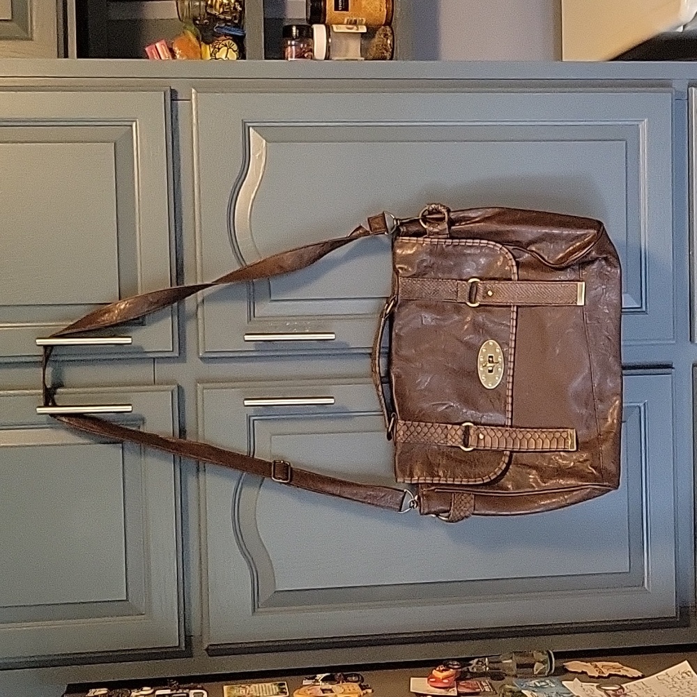NWOT Leather satchel.  Zip inside and pocket. Adjust straps. Easy closure front